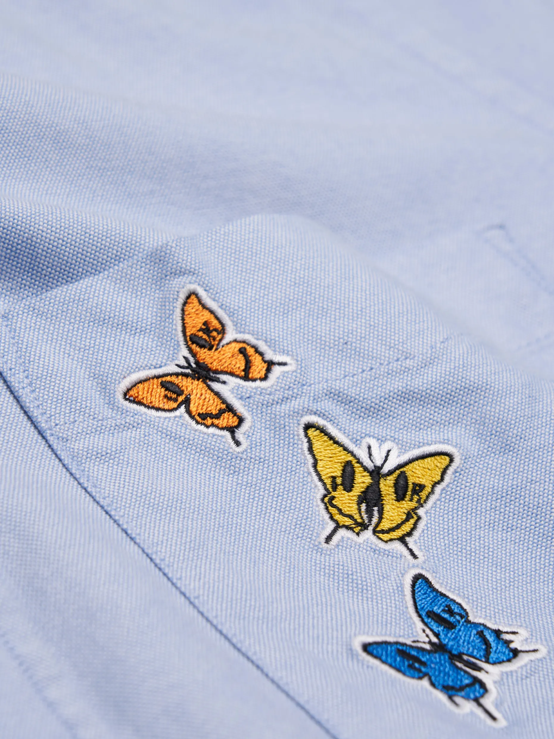 Camisa oxford com borboletas no bolso Lion x Killa|LION OF PORCHES New